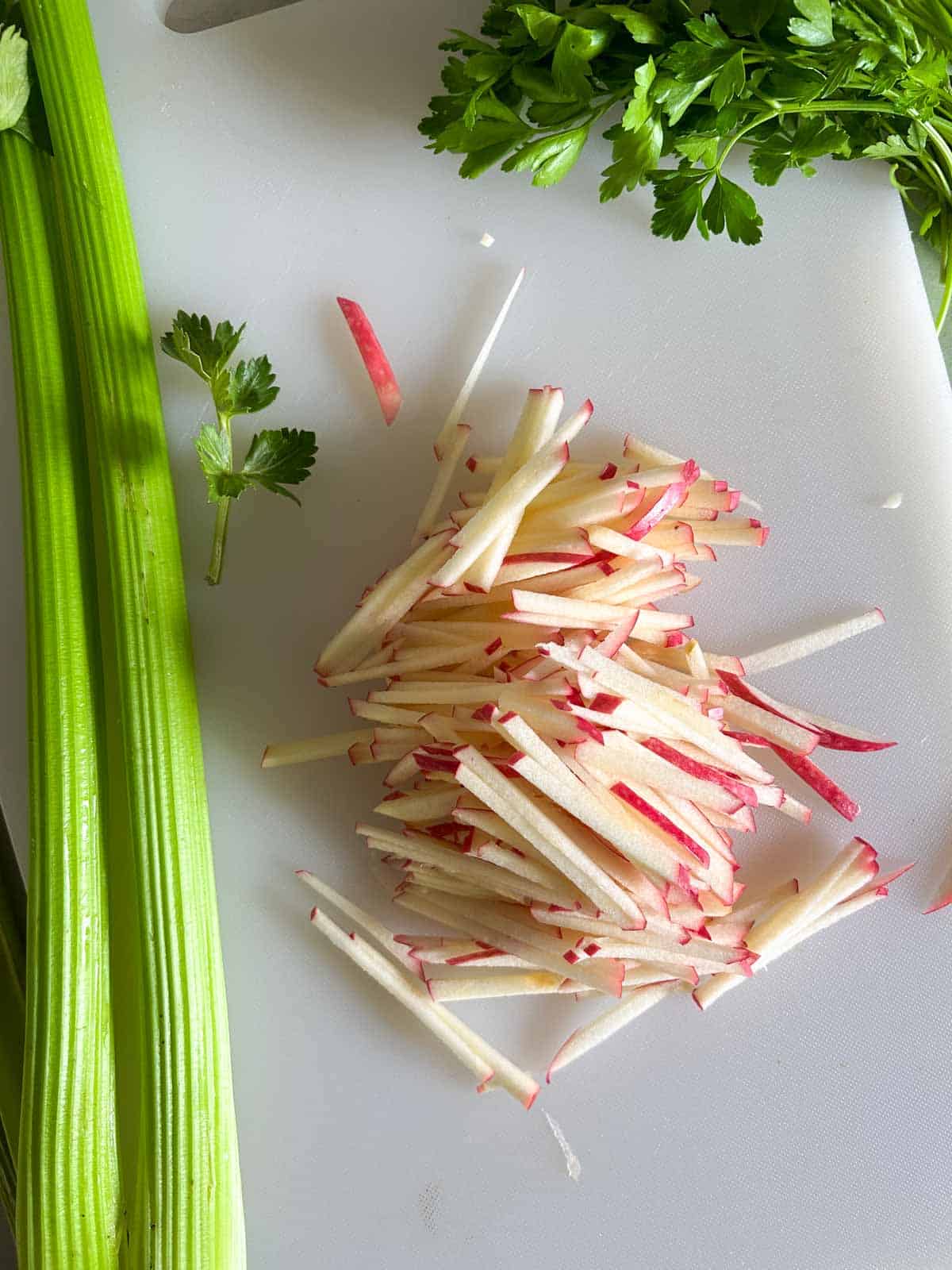 An apple julienne cut into uniform pieces